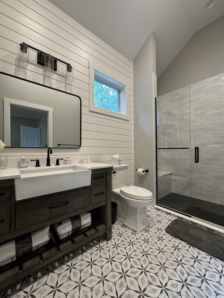 Bathroom renovation in Buchanan, MI by Barbour Construction with dual sink vanity and walk-in shower.