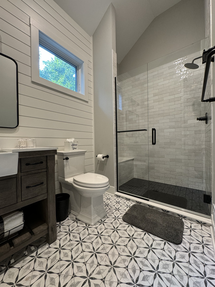Glass-enclosed shower and tile wall detail in Buchanan, MI custom home by Barbour Construction.