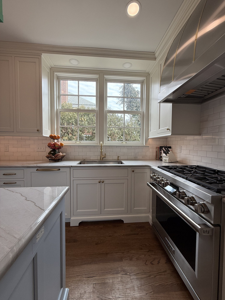 Barbour Construction kitchen with white cabinetry, brass hardware, and stainless steel range in South Bend, IN