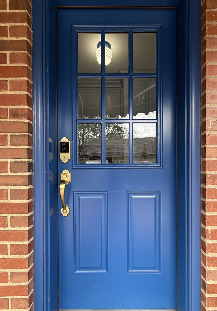 Blue front entry door with brass hardware on a custom home by Barbour Construction in South Bend, IN