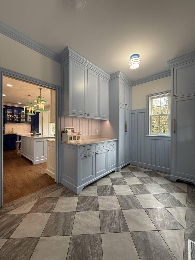 Custom blue cabinetry in transitional mudroom space by Barbour Construction in South Bend, IN