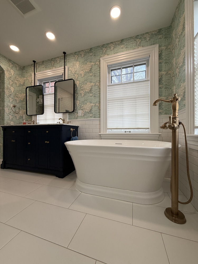 Elegant freestanding tub next to double vanity in South Bend bathroom by Barbour Construction