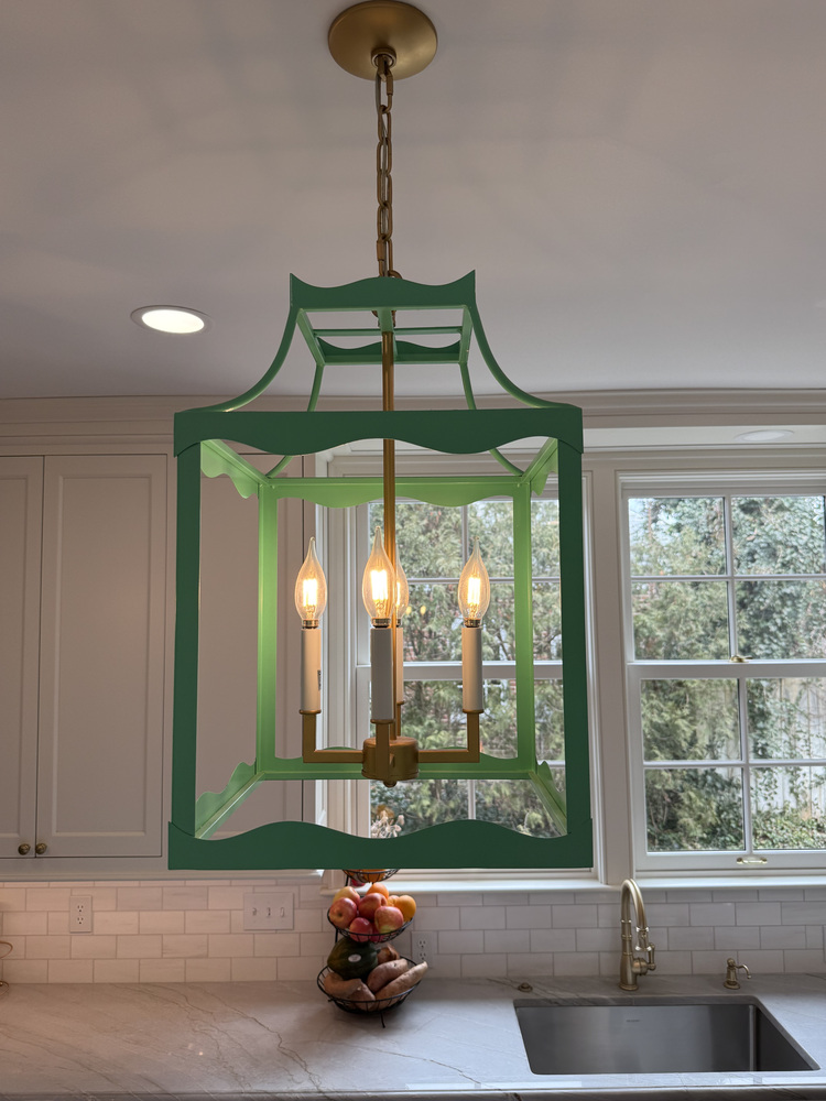 Statement green pendant light over kitchen sink in South Bend custom home by Barbour Construction