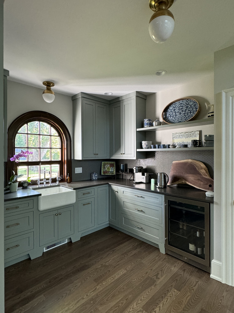 Custom bar nook with arched window and built-in cabinetry by Barbour Construction in South Bend