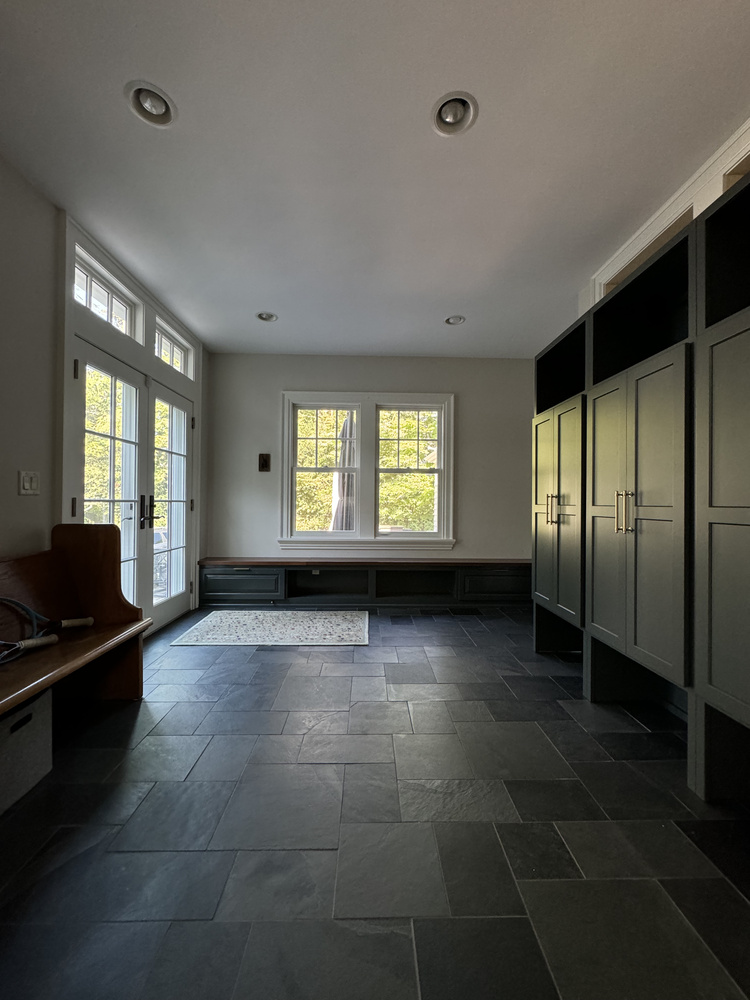 Entryway view in South Bend custom home mudroom with built-ins and French doors by Barbour Construction.
