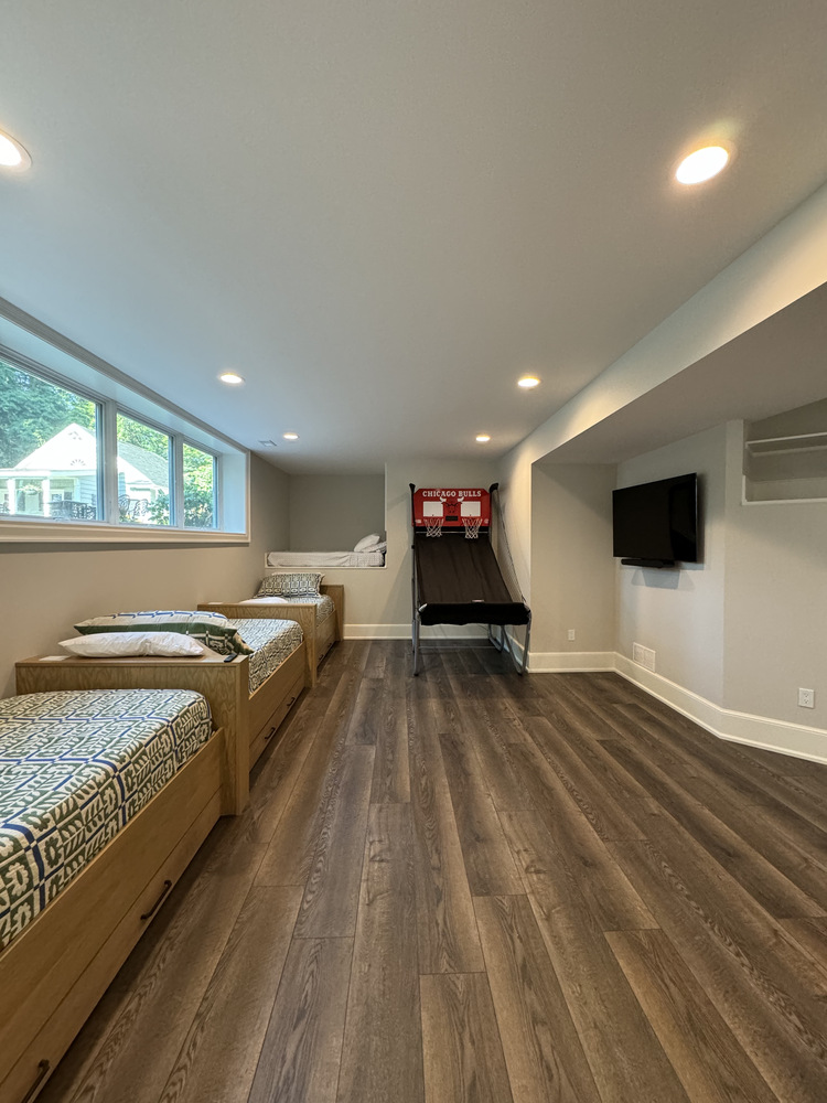 South Bend custom home basement with kid-friendly sleeping area and mini basketball game by Barbour Construction.