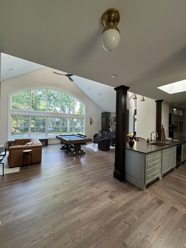South Bend custom home living room with arched windows and pool table by Barbour Construction