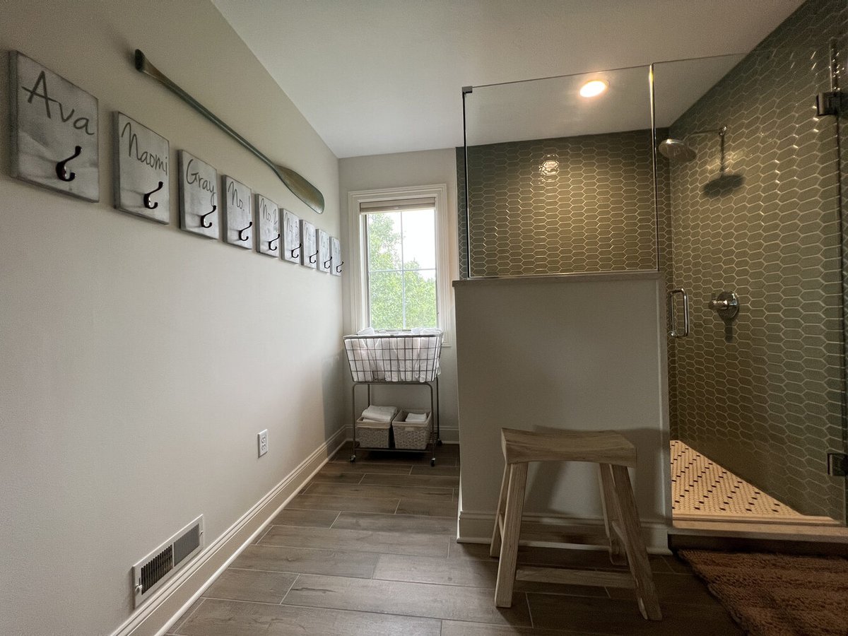 Dowagiac, MI bathroom featuring glass shower and personalized wall hooks by Barbour Construction.