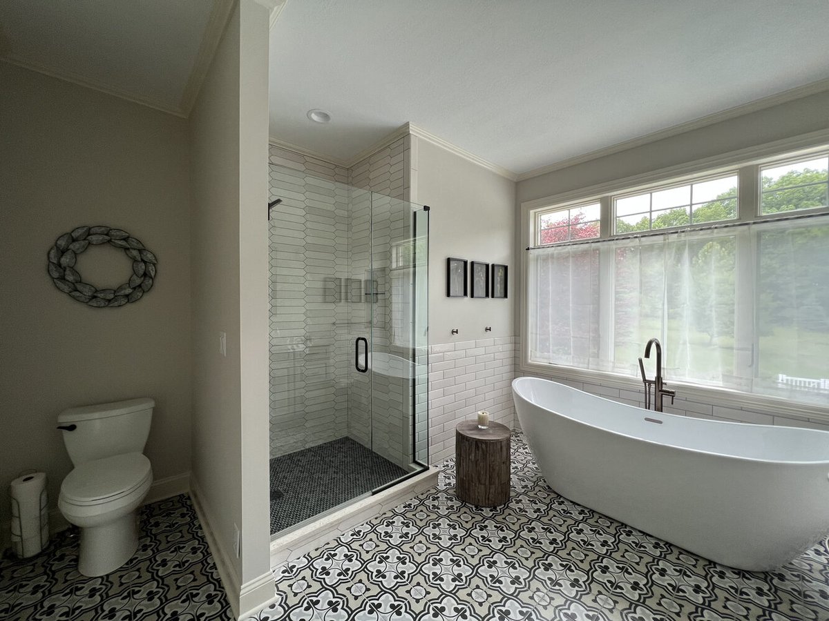 Freestanding soaking tub beside walk-in shower in Barbour Construction custom bath, Dowagiac, MI.