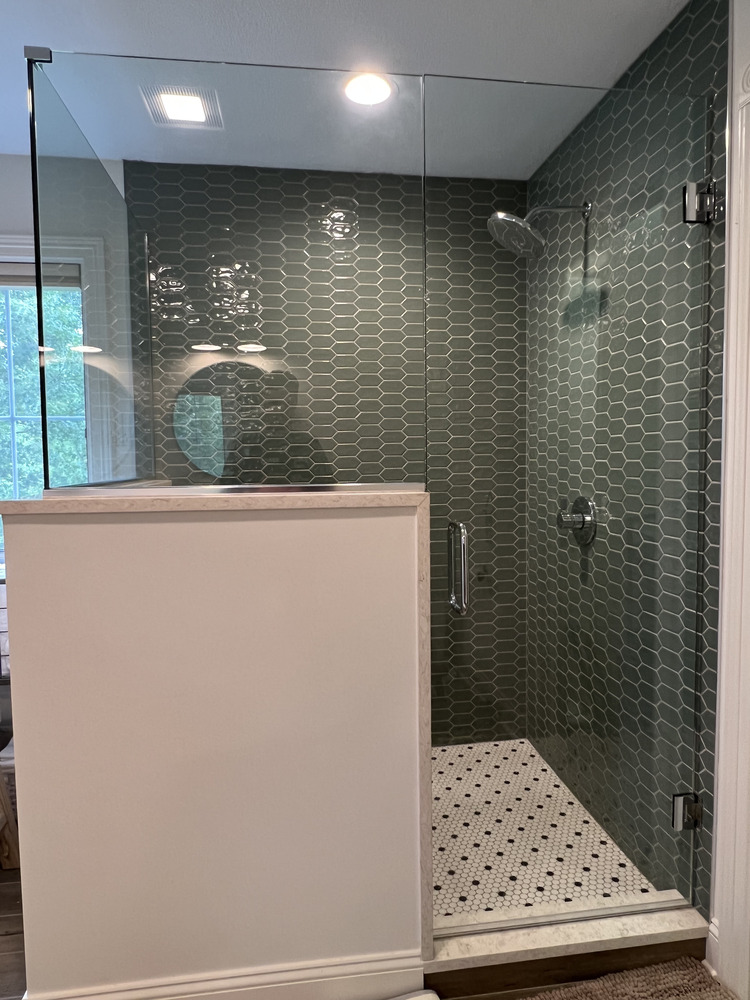 Luxurious glass shower remodel featuring geometric green tile by Barbour Construction in Dowagiac, MI.