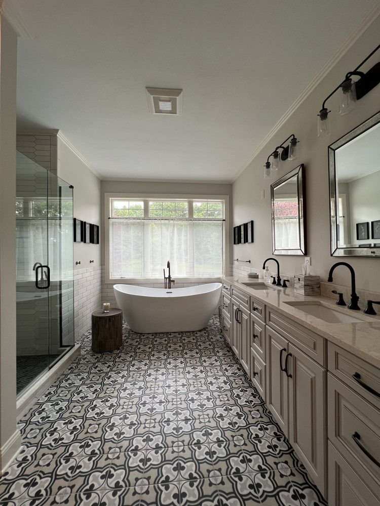 Luxury bathroom renovation in Dowagiac, MI by Barbour Construction with freestanding tub and patterned tile.