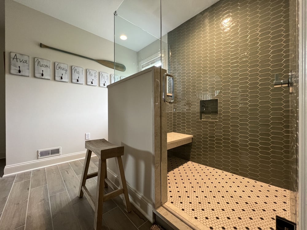 Walk-in shower and personalized wall decor in Barbour Construction’s Dowagiac, MI bathroom remodel.