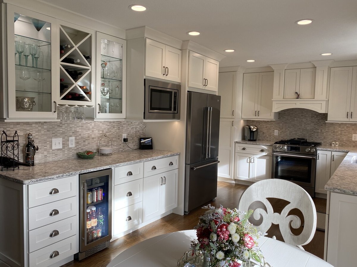 Elegant kitchen dining space and cabinetry in Goshen, IN custom home by Barbour Construction.