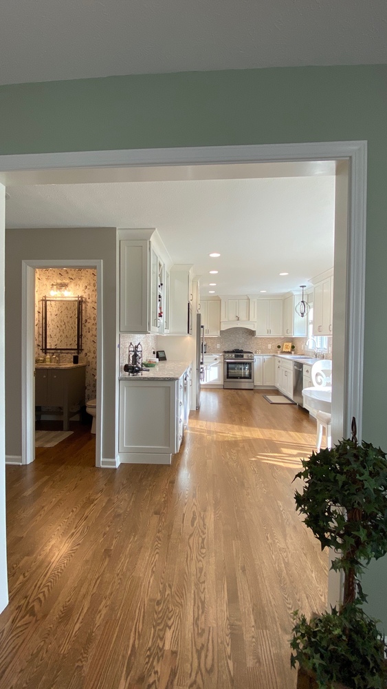 Hallway view into remodeled kitchen and powder room by Barbour Construction in Goshen, IN.