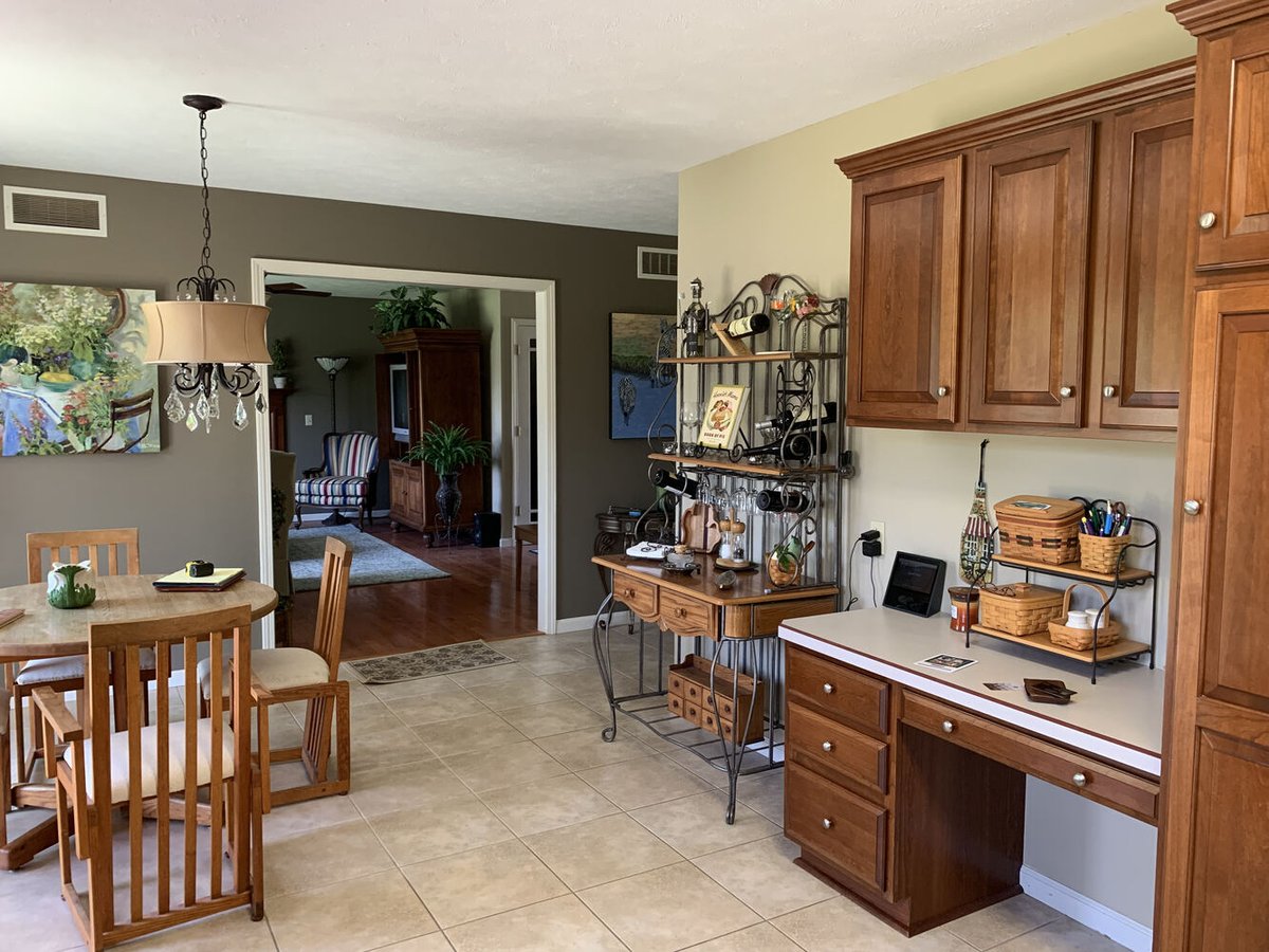 Pre-remodel kitchen corner with built-in desk and wooden cabinetry in Goshen, IN home by Barbour Construction.