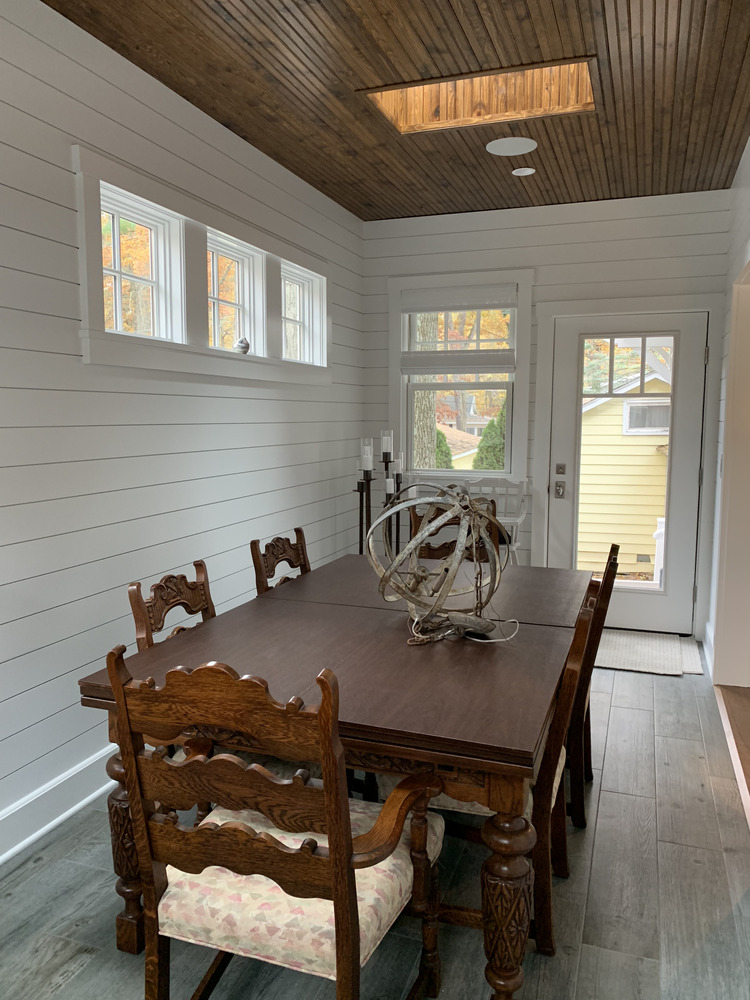 Classic dining space with shiplap walls and wood detailing in a custom home by Barbour Construction in Grand Beach, MI.