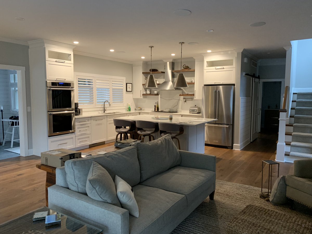 Modern custom kitchen with island seating and stainless steel appliances by Barbour Construction in Grand Beach, MI.