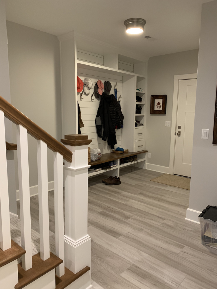 Organized entry area with bench seating and storage in a custom home by Barbour Construction in Grand Beach, MI.