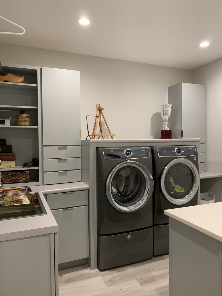 Organized laundry space with modern appliances in a Grand Beach custom home by Barbour Construction.