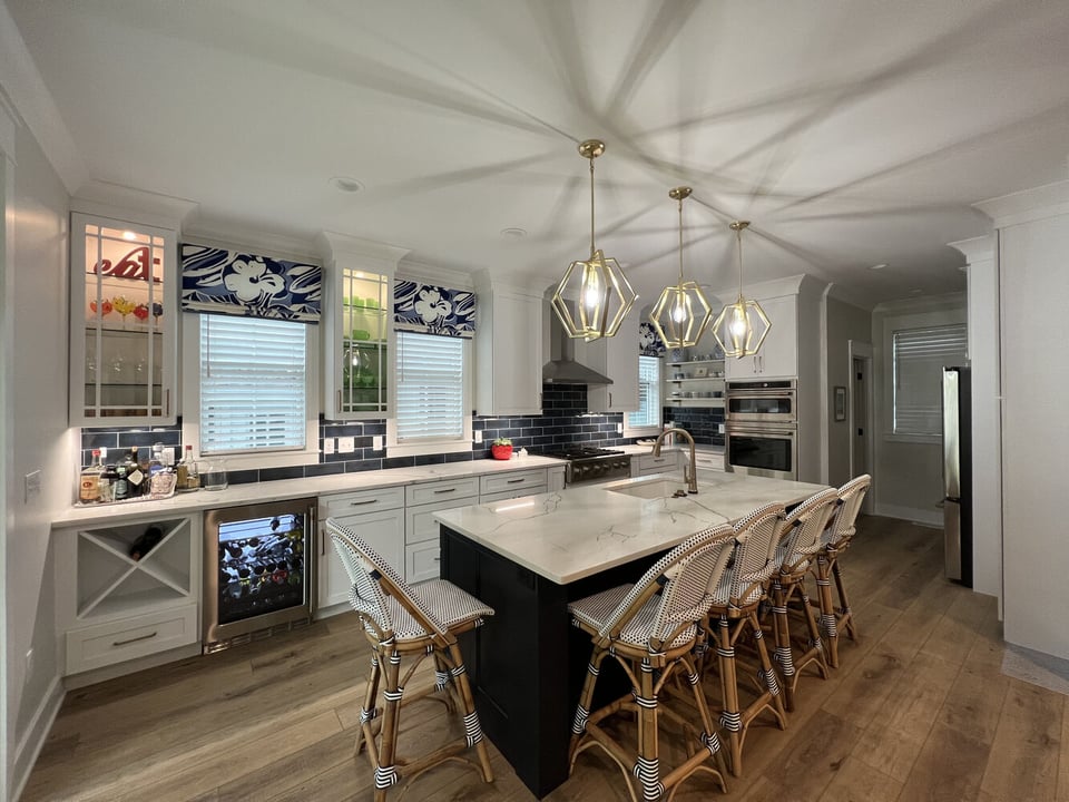 Elegant custom home kitchen with decorative cabinets and bar seating by Barbour Construction in Grand Beach.