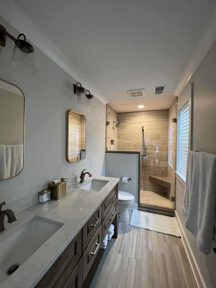 Grand Beach custom bathroom with dual-sink vanity and walk-in shower by Barbour Construction.