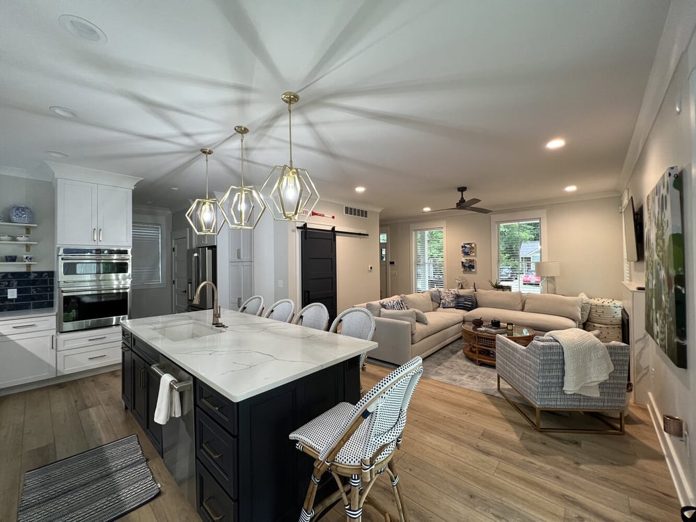 Stylish Grand Beach custom home interior featuring a modern kitchen and neutral-toned living room by Barbour Construction.
