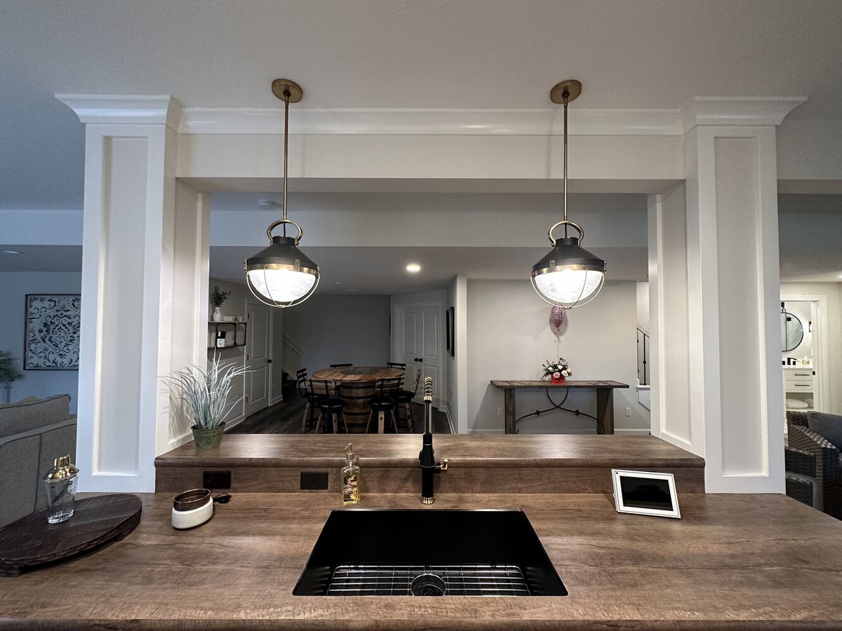 Bar sink with wood countertop and pendant lights in Barbour Construction home in New Carlisle, IN.
