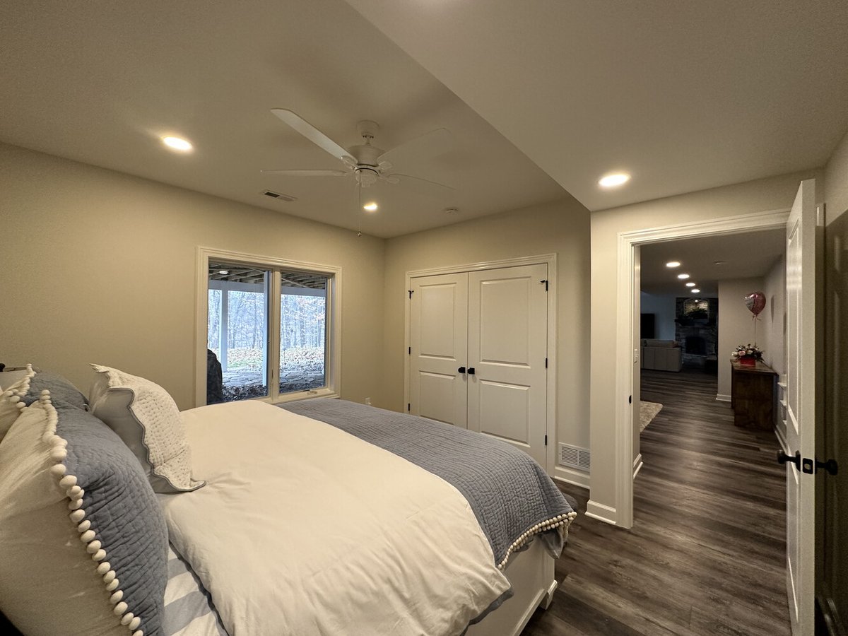 Bedroom interior view with closet and hallway access in New Carlisle custom home by Barbour Construction.