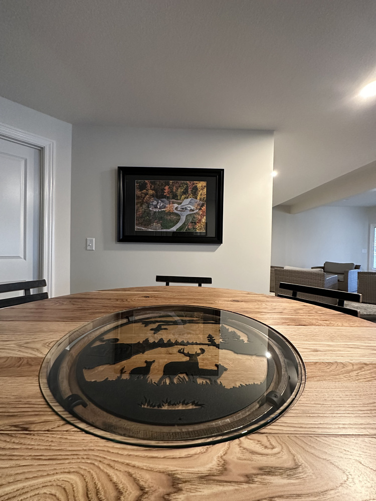 Close-up of custom barrel dining table with wildlife inlay in Barbour Construction home in New Carlisle, IN.