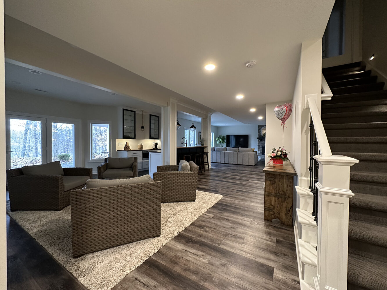 Finished basement with lounge area, bar, and walk-out views in New Carlisle by Barbour Construction.