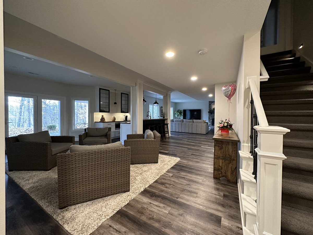 Finished basement with lounge area, bar, and walk-out views in New Carlisle by Barbour Construction.