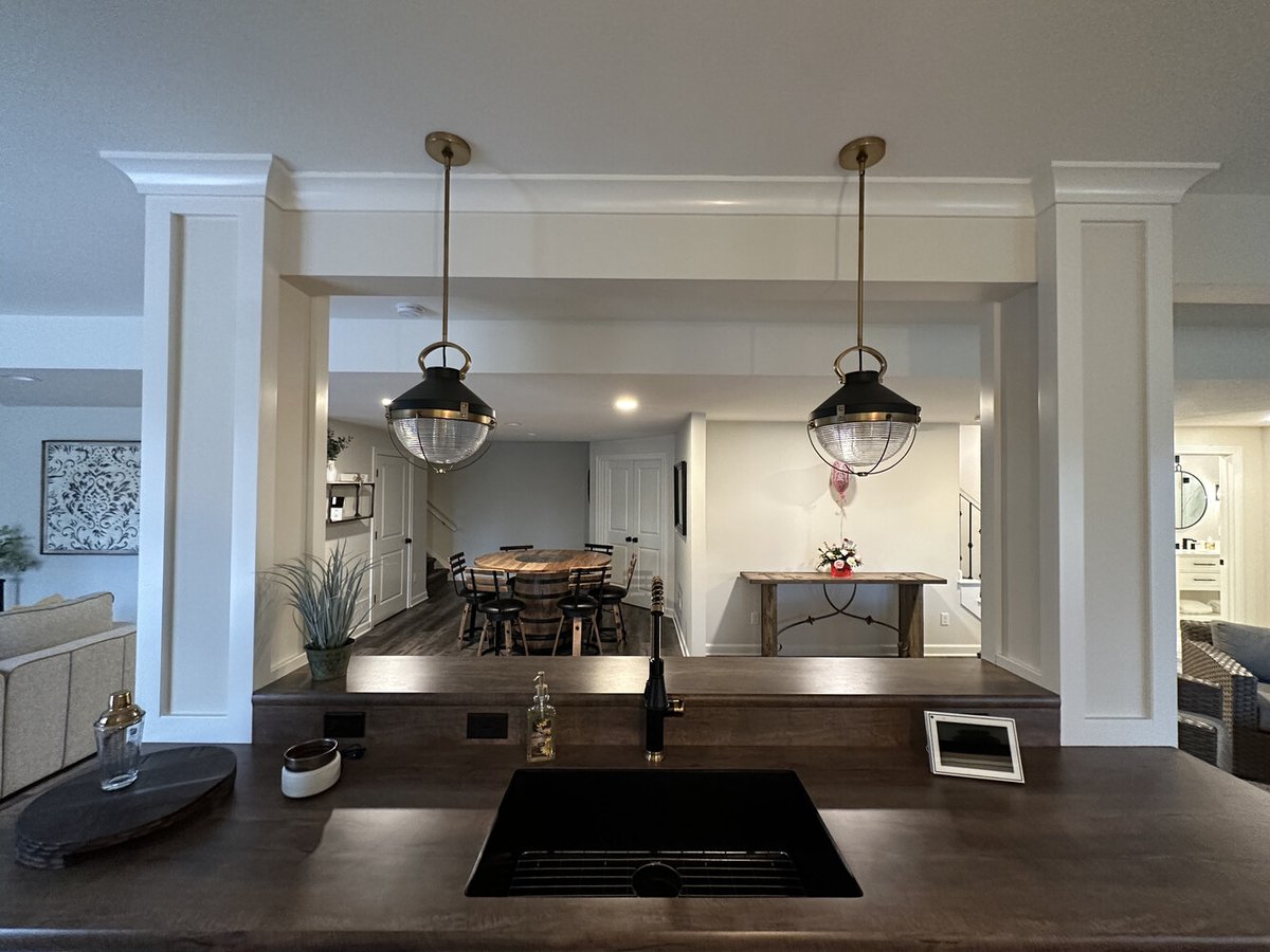 Rustic-modern bar space with wood countertops and recessed lighting in Barbour Construction’s custom home in New Carlisle, IN.