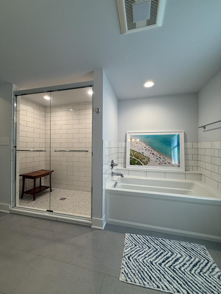 Custom tub and walk-in shower combo with white subway tile in Sawyer, MI home by Barbour Construction.