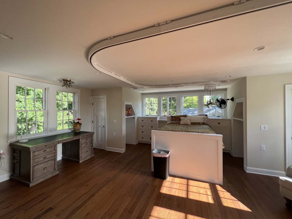 Custom bedroom with star-shaped ceiling light and desk area by Barbour Construction in South Bend, IN.