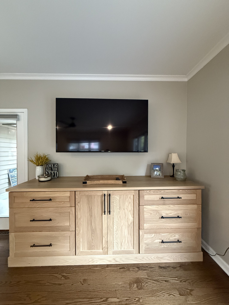 Built-in entertainment center with natural wood cabinetry in South Bend custom home by Barbour Construction.