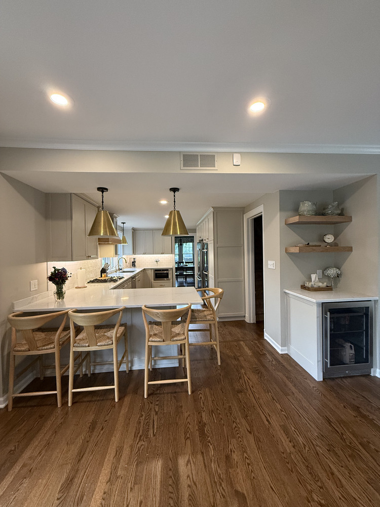 Full view of custom kitchen with pendant lighting and hardwood flooring by Barbour Construction in South Bend, IN.