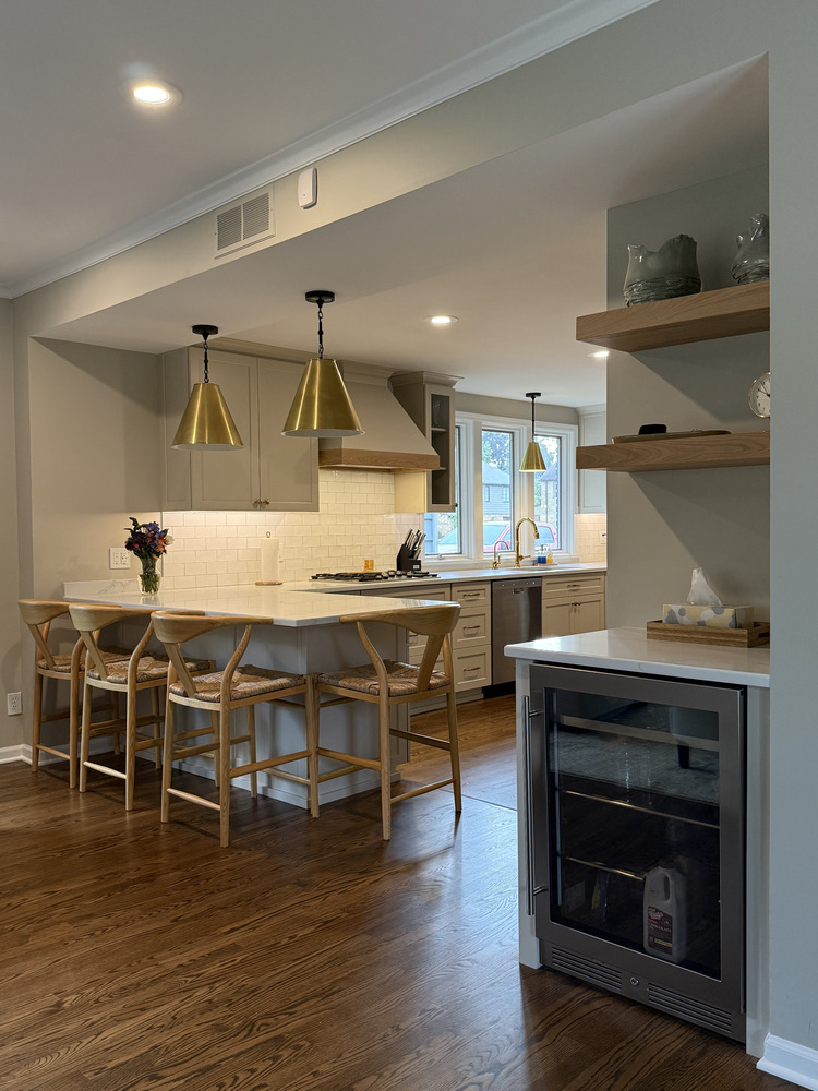 Kitchen design featuring island seating and display shelving by Barbour Construction in South Bend, IN.