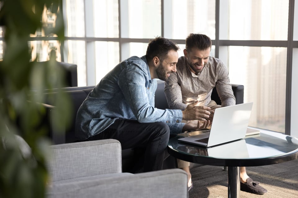 Stock Image of Two People at a Computer Using BuilderTrend